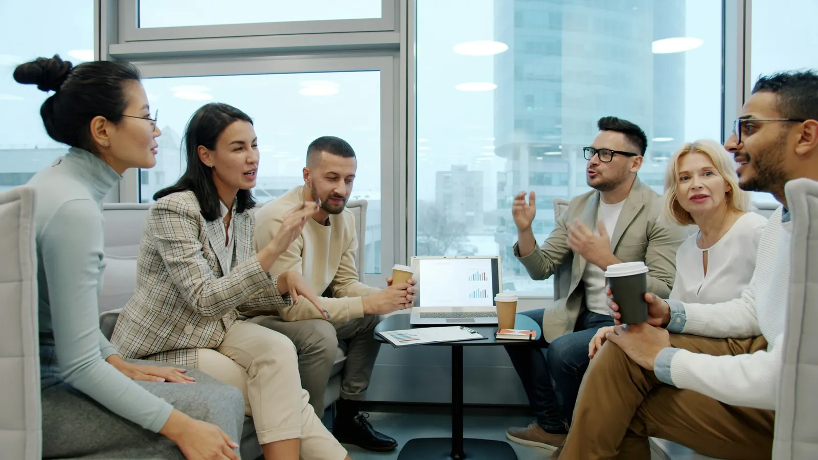An international team in discussion around a table in a modern office